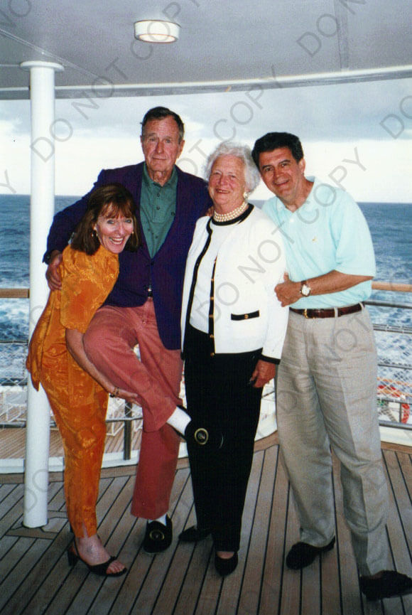 Former President George H.W. Bush and Barbara Bush pose with Elly McGuire and forever fiance Ron Trotta on a yacht in Greece. Elly is holding up President Bush's foot to show off his slippers with the Presidential seal on thm.