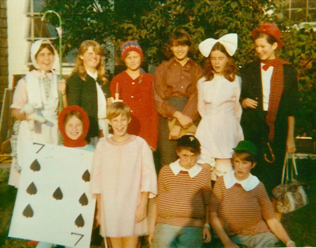 Every year Elly McGuire had a themed birthday party. This vintage picture is Elly, age ten, with nine of her friends all dressed up as Storybook characters. Elly's was dressed as the Knave of Hearts from Alice in Wonderland.